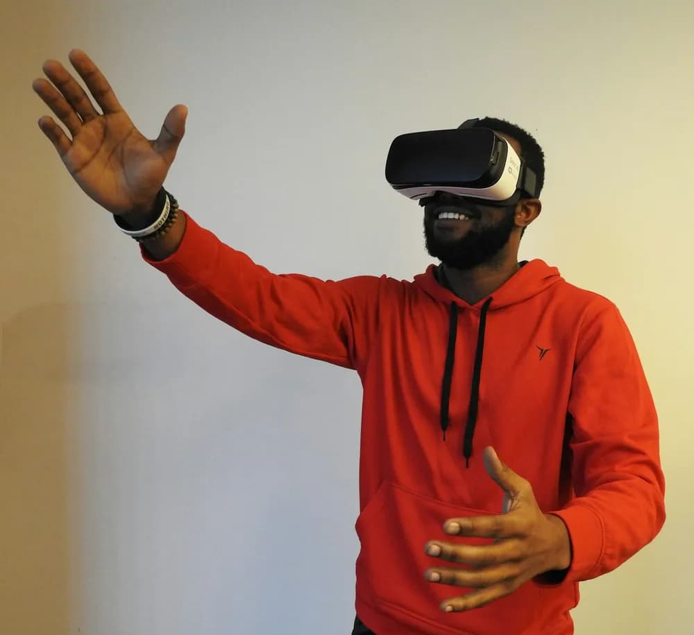 Player in a VR headset with a raised hand